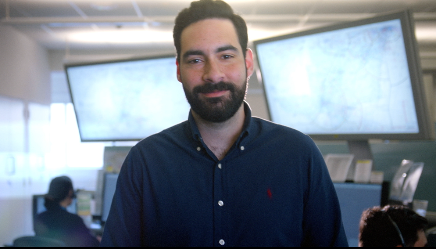 Male air traffic controller stands in training room